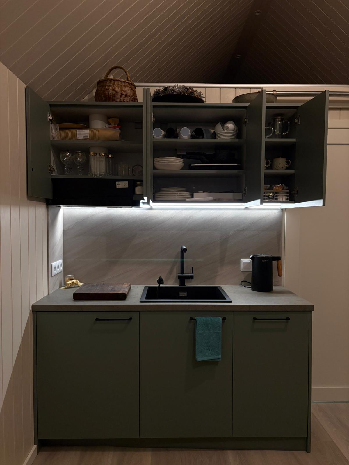 Kitchen detail with teal cabinets and LED lighting