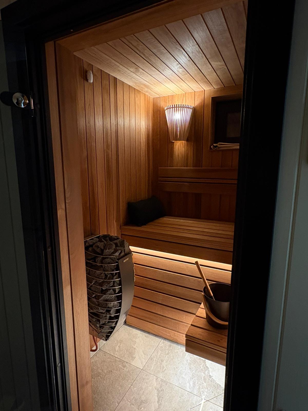 Sauna interior with wooden walls and heater
